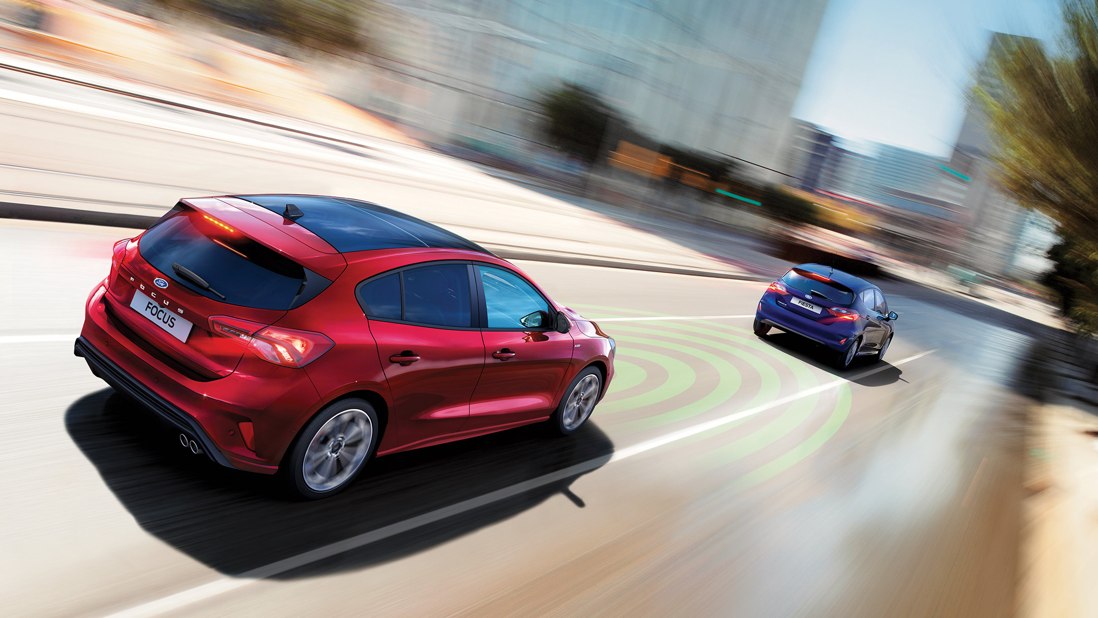 Red Ford Focus trailing another car with active braking indicating