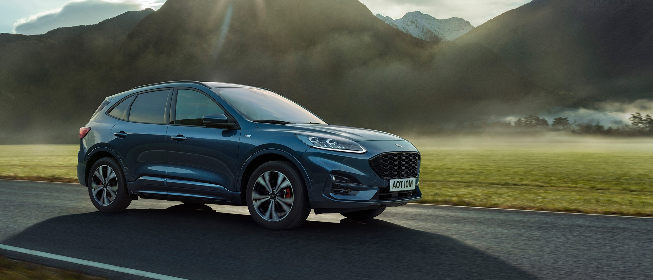Ford Kuga side view driving by mountain Ford Kuga side view driving by mountain