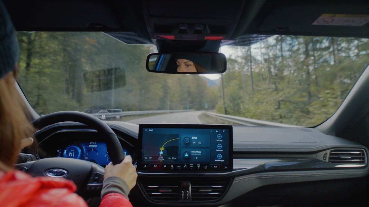 Interior view of driver driving on country road