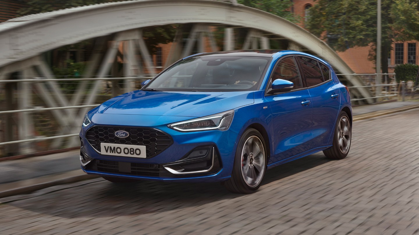New Blue Ford Focus driving on a bridge
