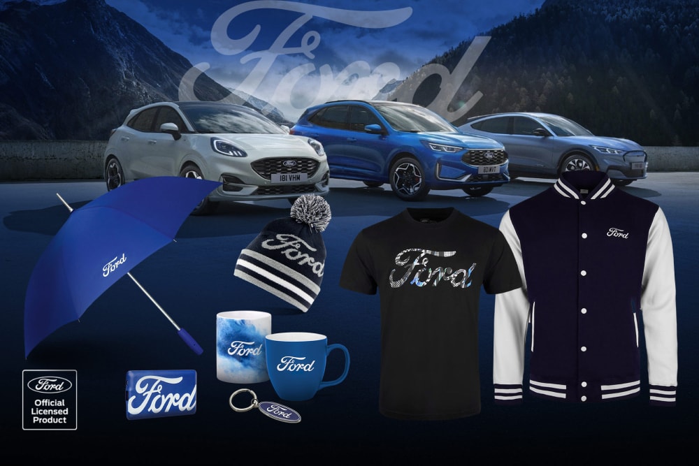 Colecție de produse Ford care prezintă diverse vehicule Ford în fundal, cu umbrelă, căni și articole cu îmbrăcaminte cu marca Ford.