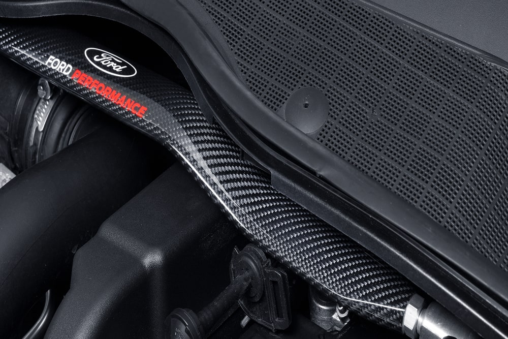Prim-plan al unei componente de motor Ford Performance în interiorul compartimentului motorului.