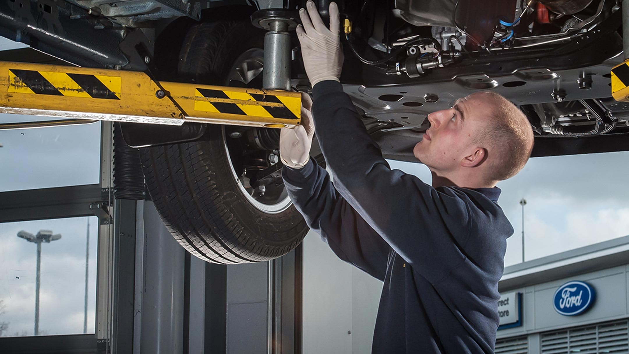 Transit Connect showing servicemen inspecting car