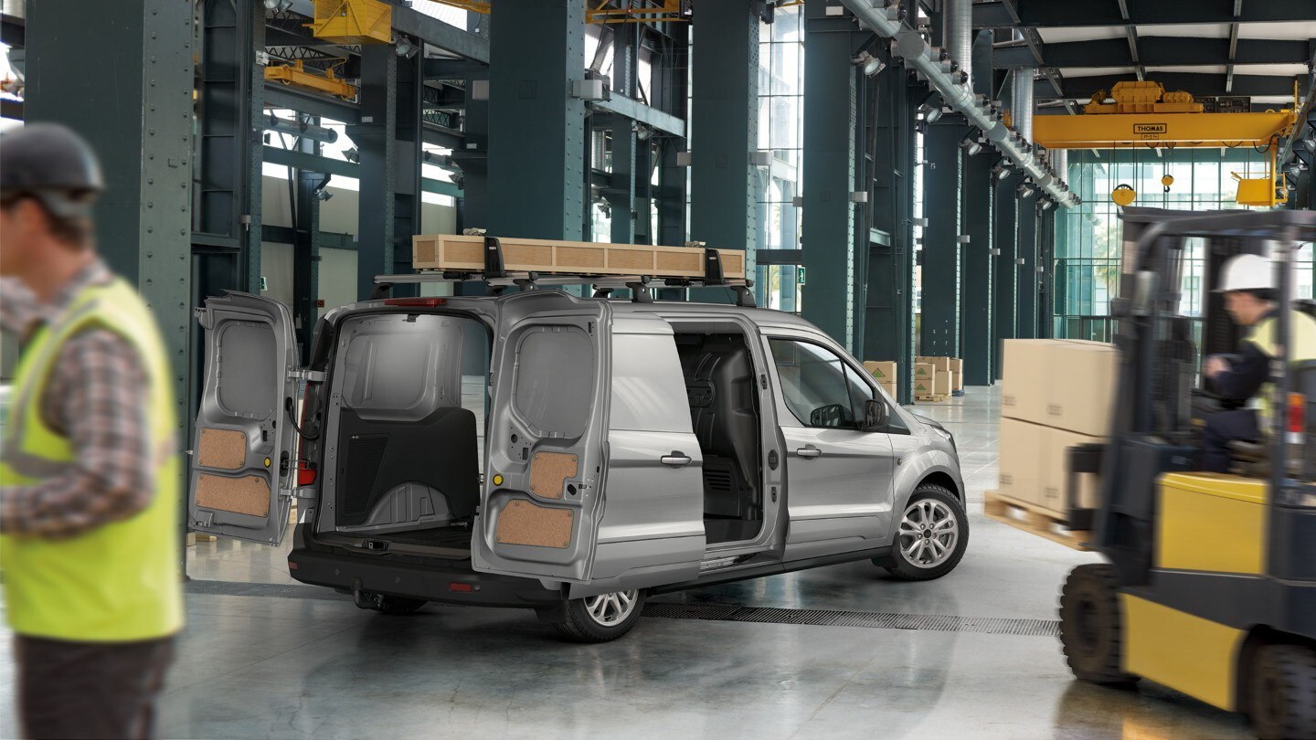 Ford Transit Connect parked next to modern building