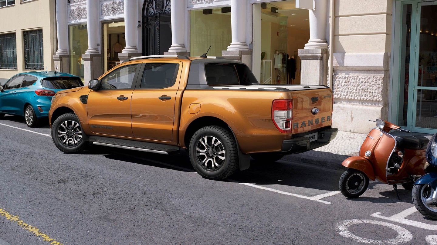 Orange Ford Ranger leaving parking bay