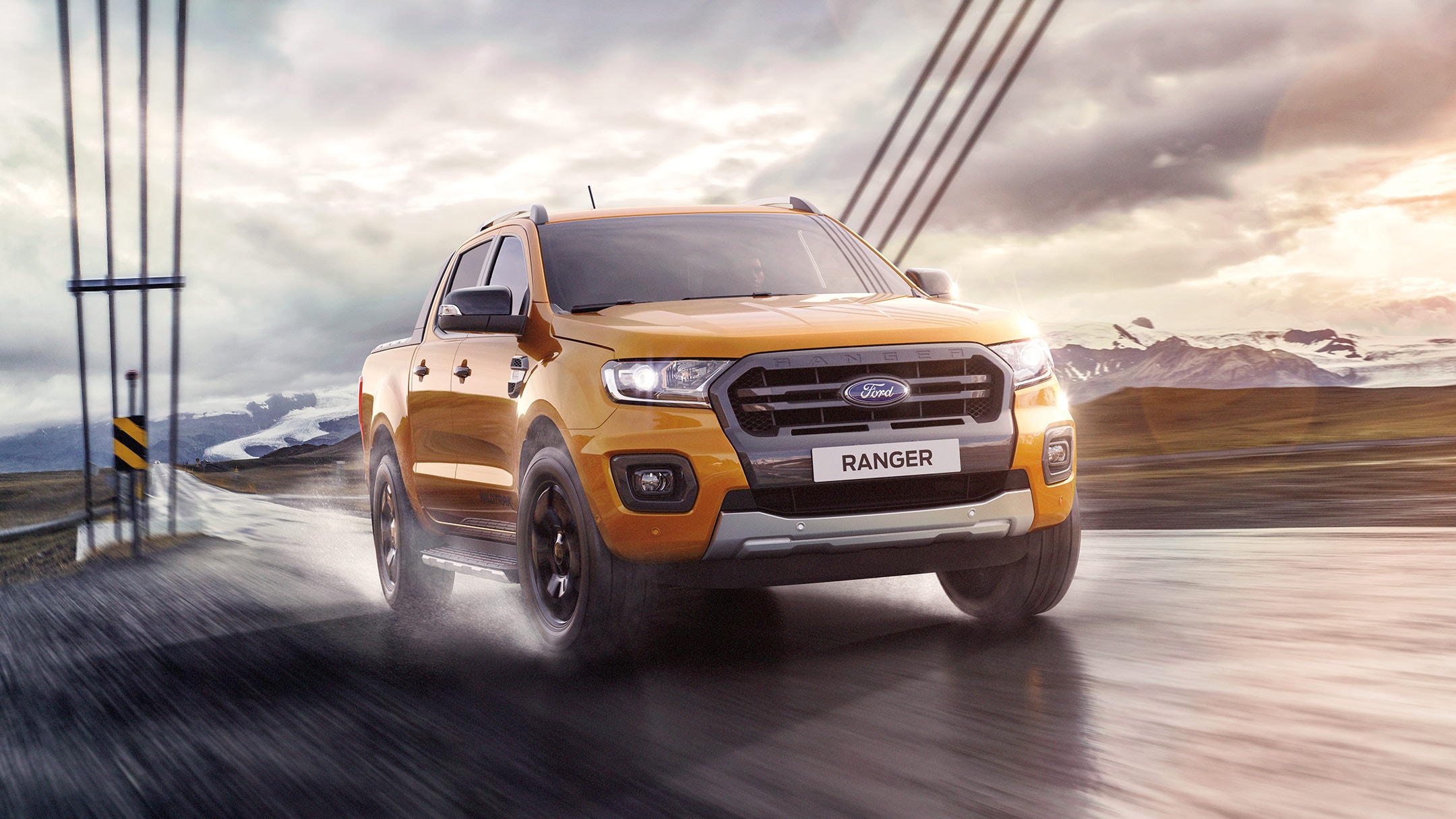 Orange Ford Ranger front view on wet road