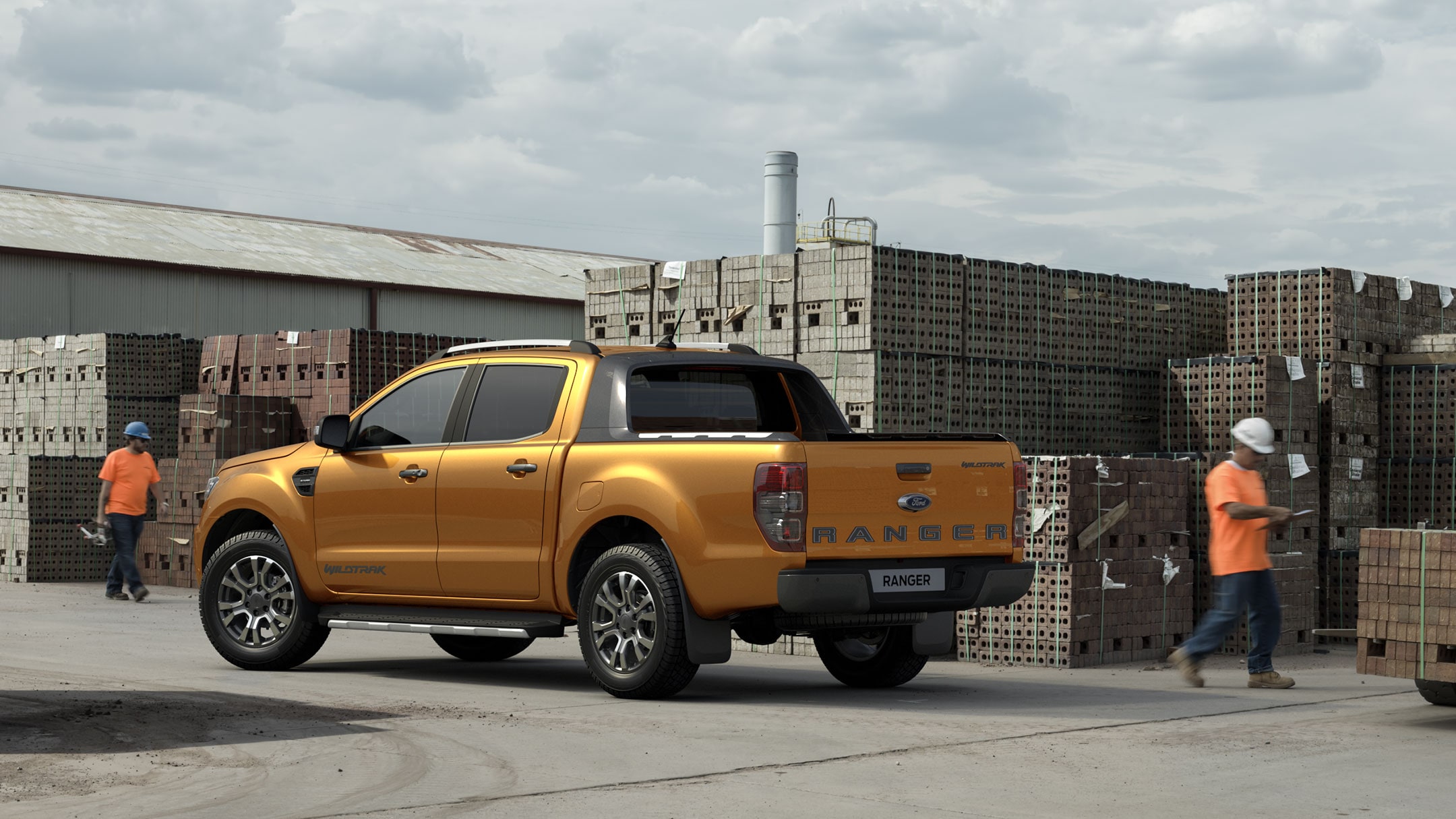 Orange Ford Ranger parked in building yard