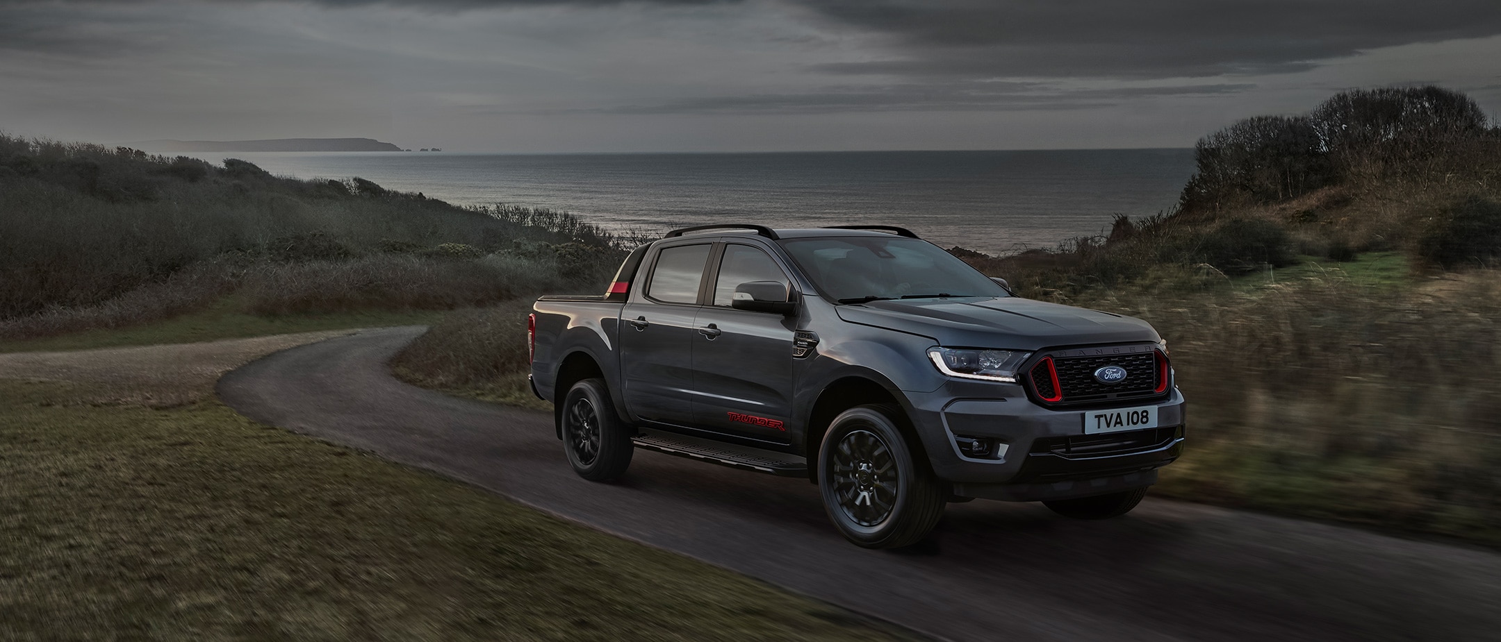 Ford Ranger thunder driving through a countryside, front three quarter view