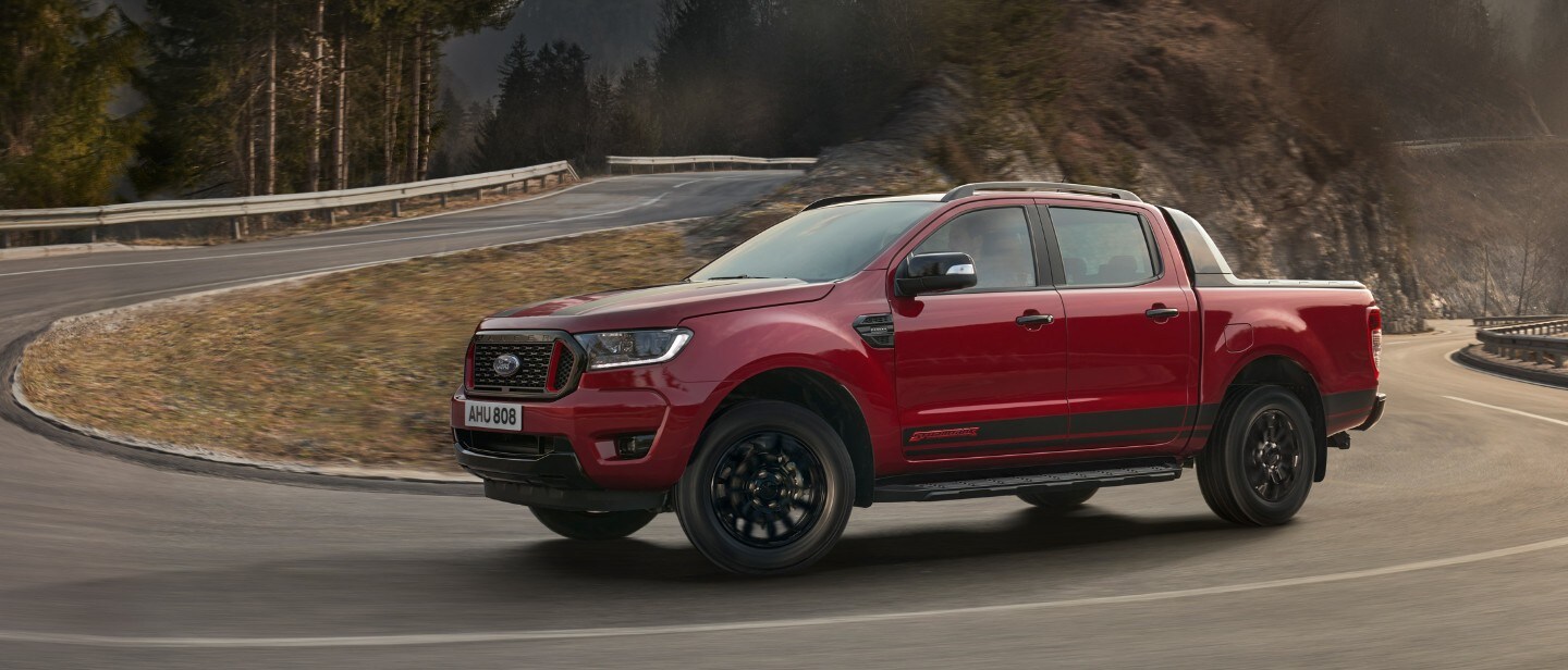 Ford Ranger Stormtrak driving through a countryside on bendy road, side view