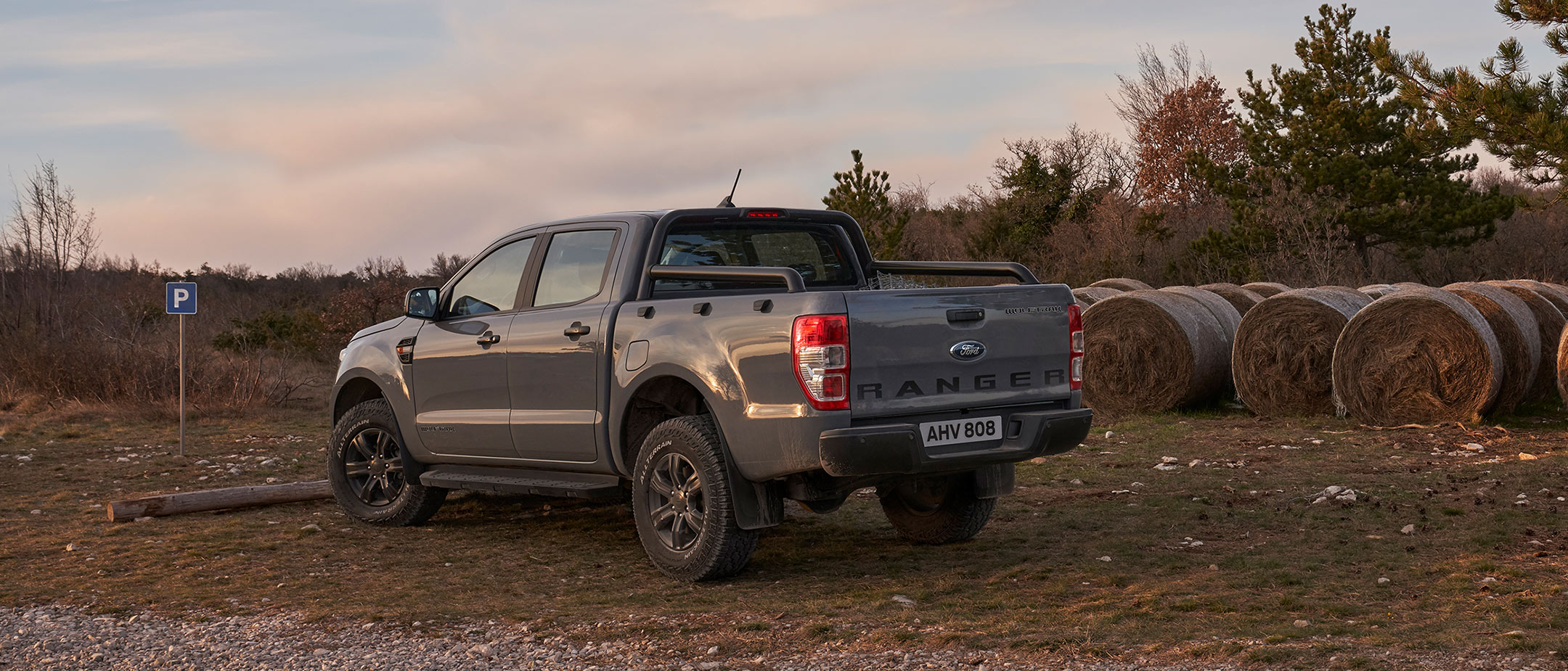 Rear view of a Ford Ranger Wolftrak parked near haystacks