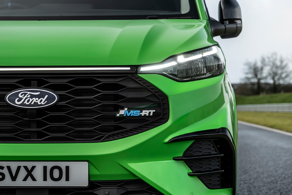 Front view  close-up of LED headlines and MS-RT logo on a green Ford Transit Custom MS-RT.