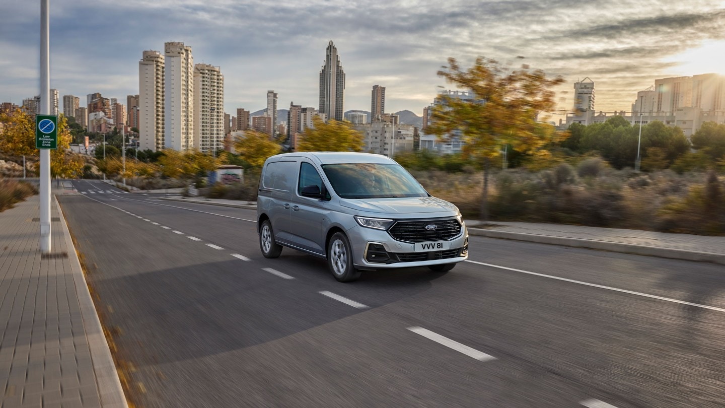 Noul Ford Transit Connect în culoarea Stardust Silver se deplasează pe o șosea.