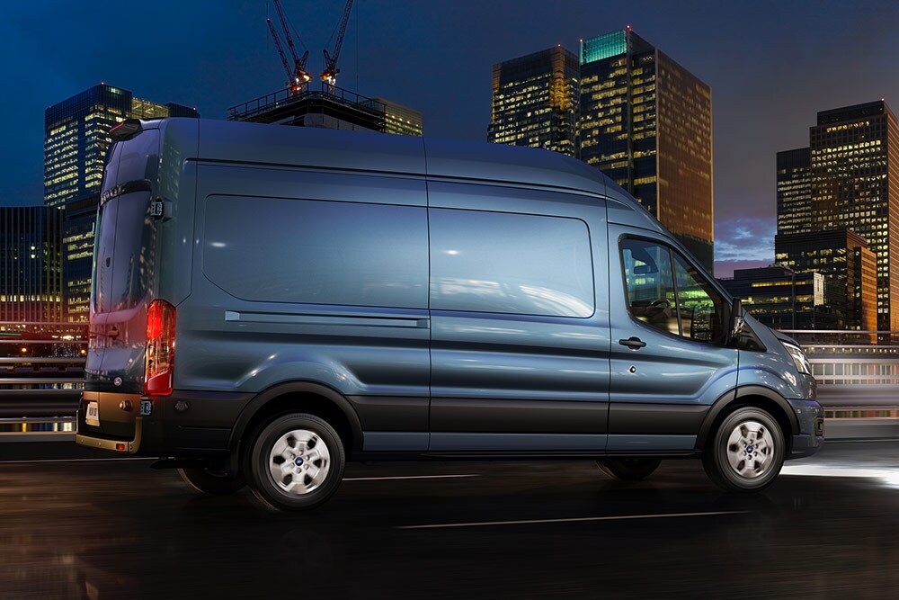 Ford Transit Van driving in the city at night.