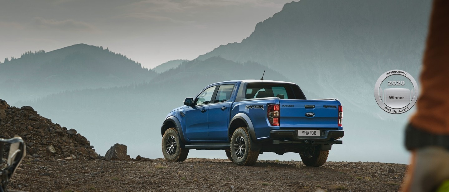 Blue Ford Ranger Raptor parked in the mountains