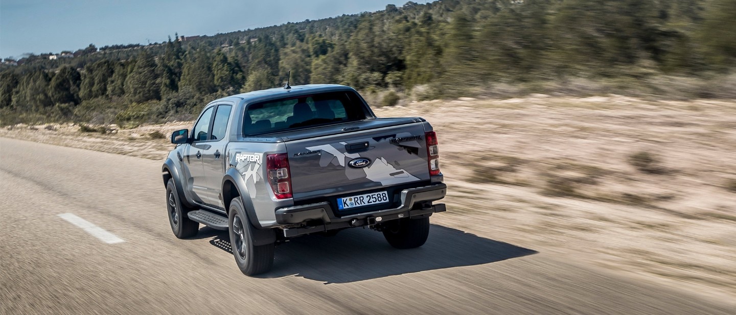 Ford Ranger Raptor driving past forest