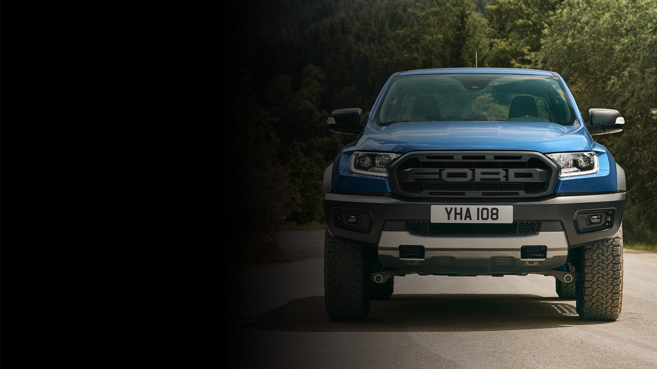 Blue Ford Ranger Raptor parked, front grill view