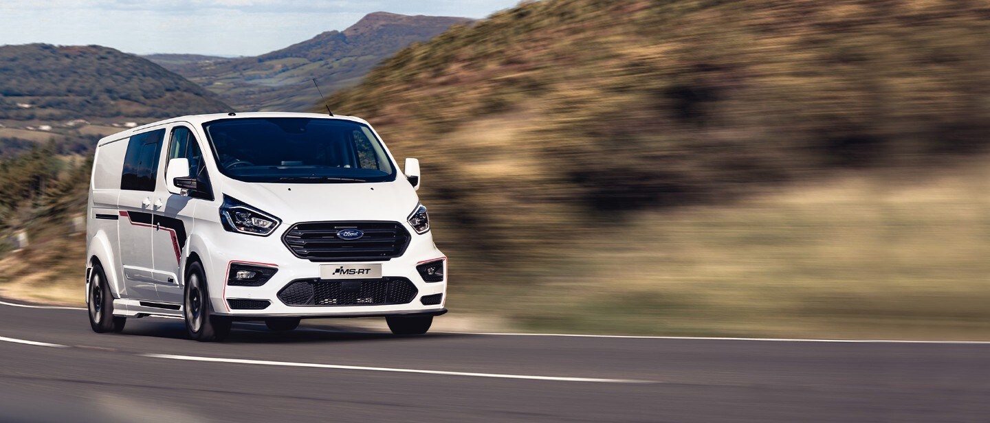 White Ford Transit Custom MS-RT driving through the countryside White Ford Transit Custom MS-RT driving through the countryside