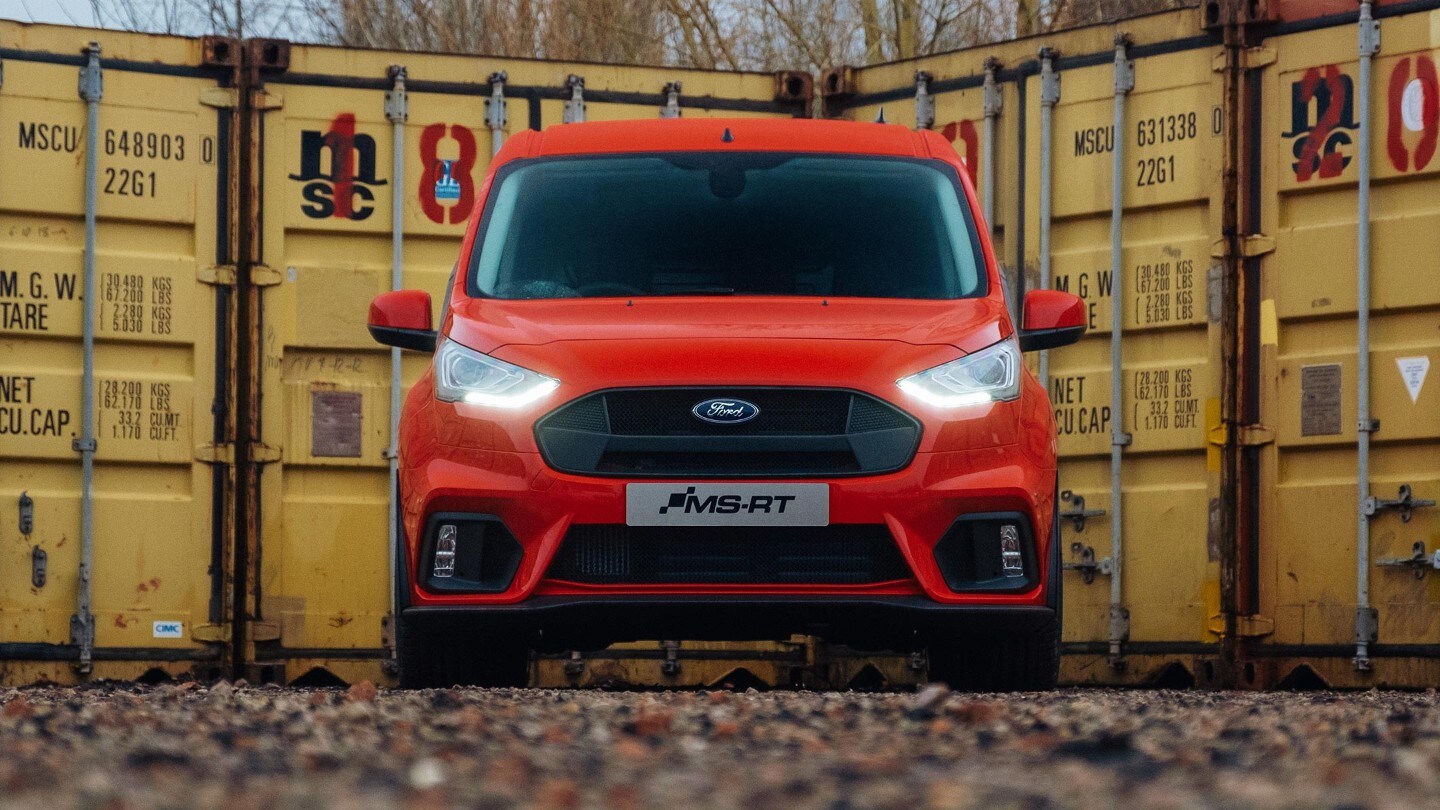 Front view of the Ford Transit Connect MS-RT parked in front of shipping containers.