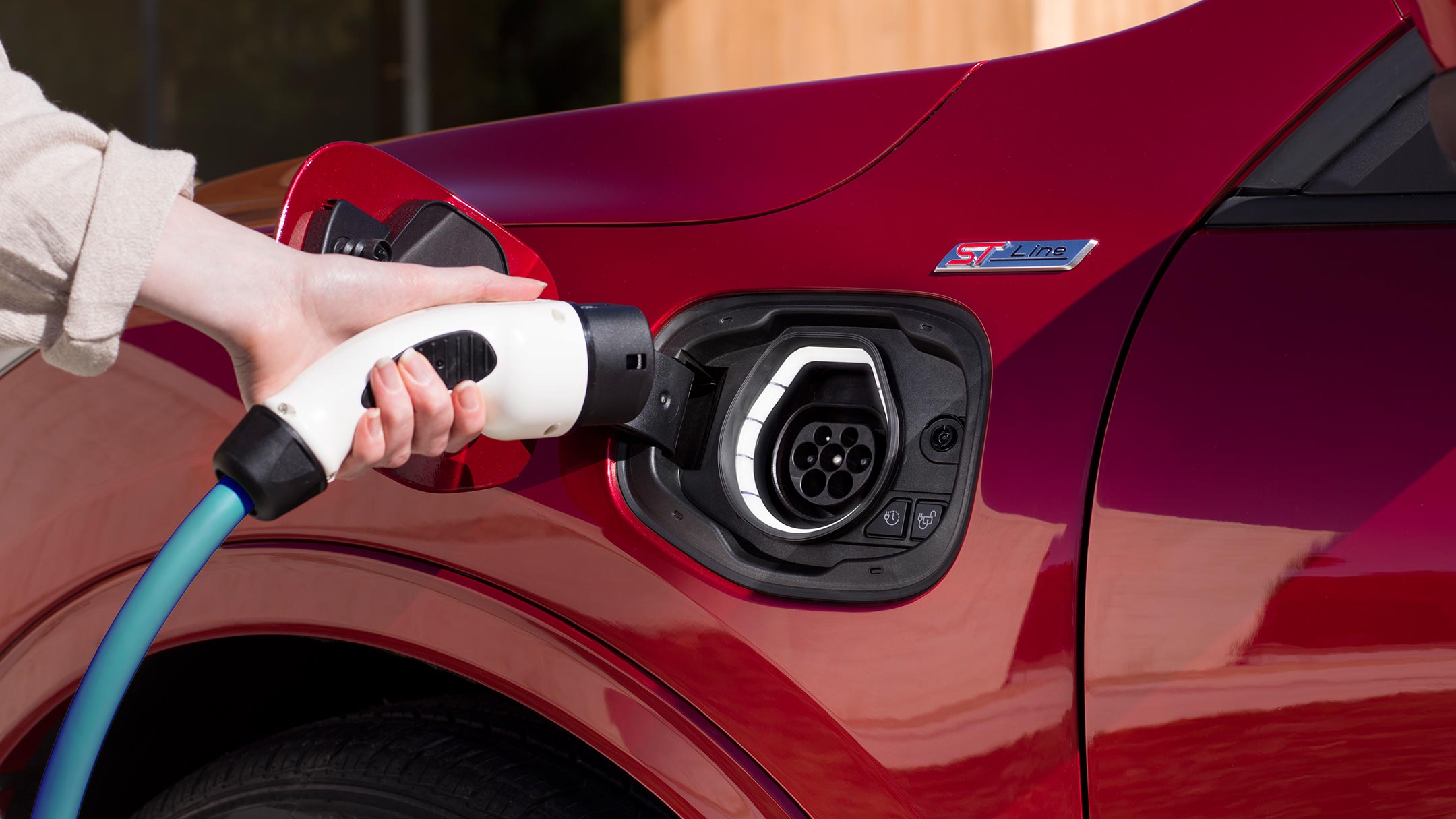 A woman charging a New Ford Kuga Plug-In Hybrid