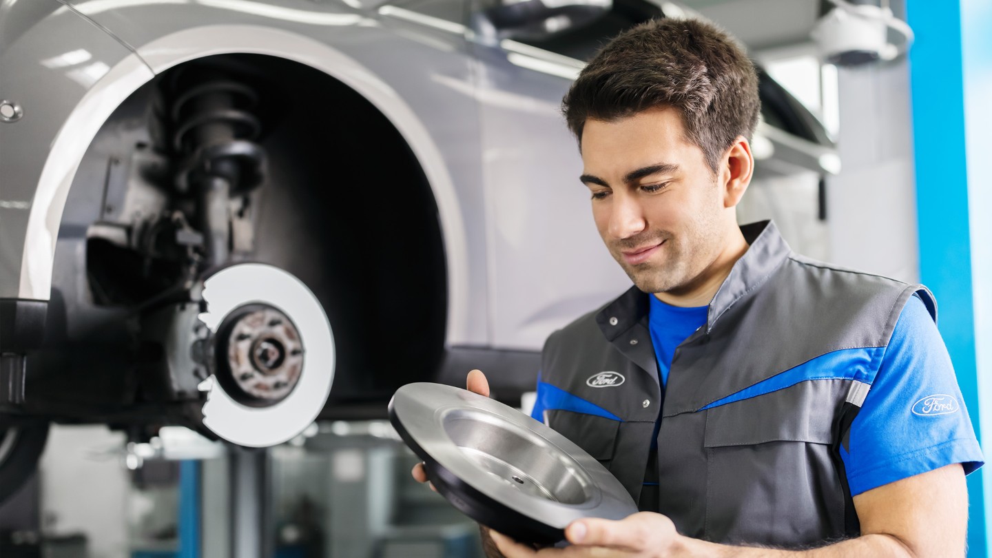 Technician inspecting a brake rotor