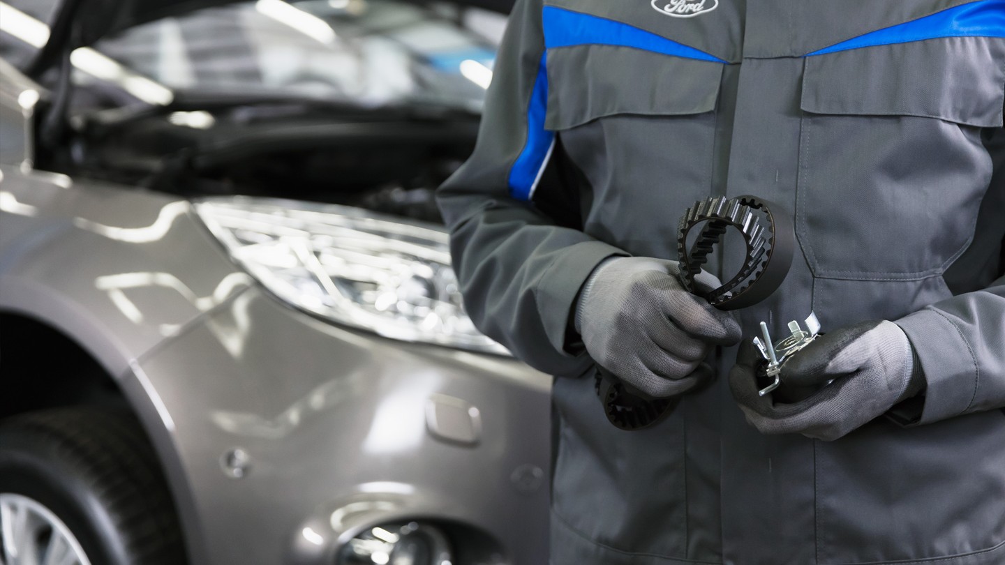 Technician holding a timing belt kit